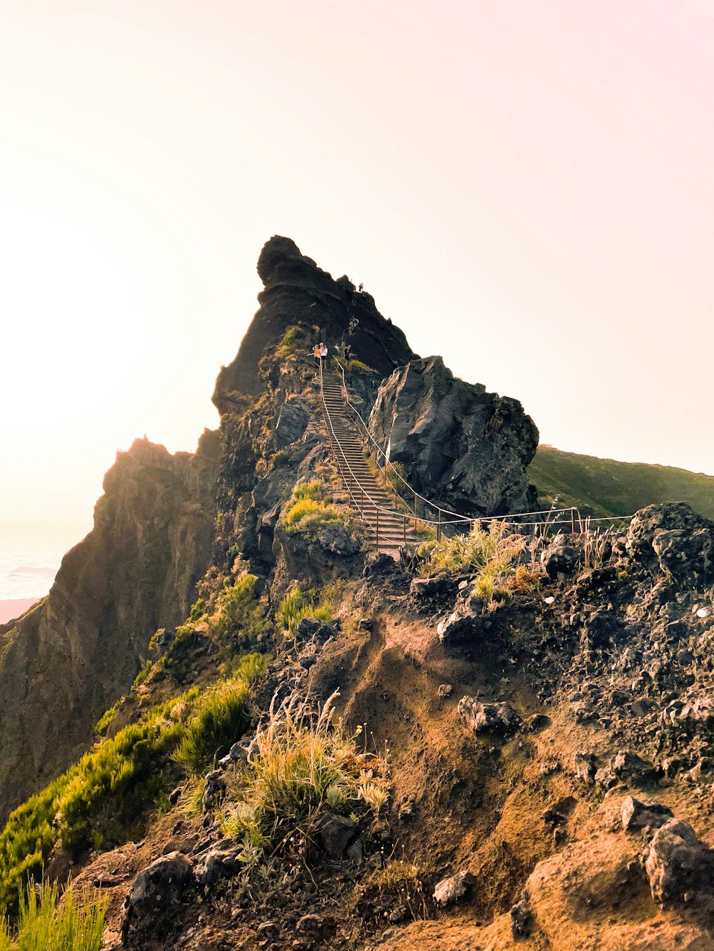 a rocky mountain with a path going up the side of it