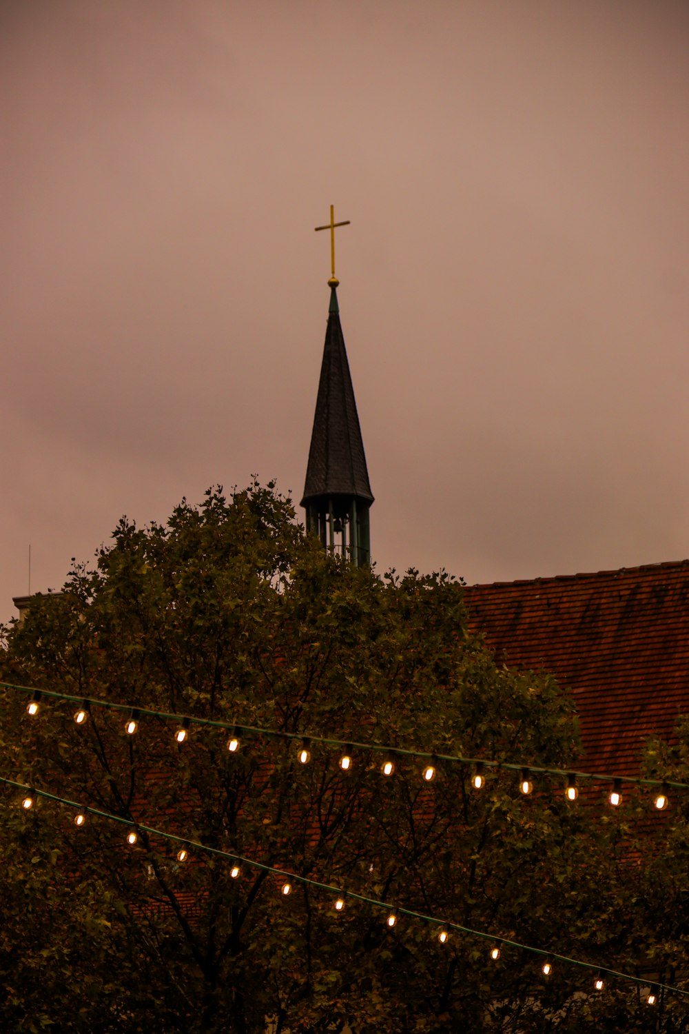 a church steeple with a cross on top of it