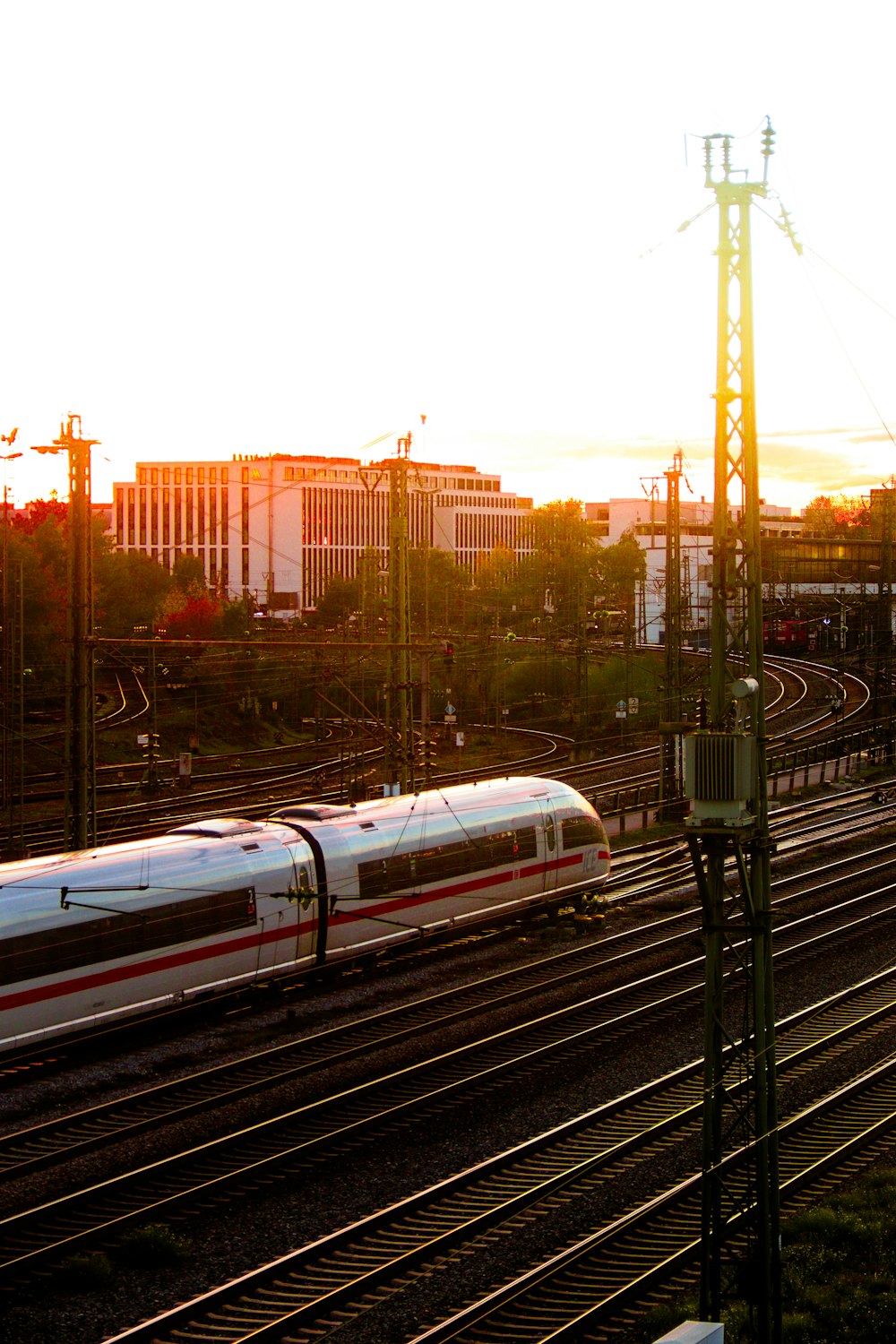 a train traveling down train tracks near a city