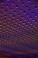 a ceiling with blue lights hanging from it