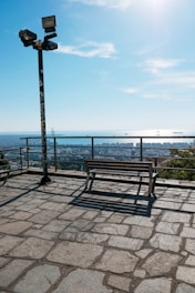 a wooden bench sitting on top of a stone floor