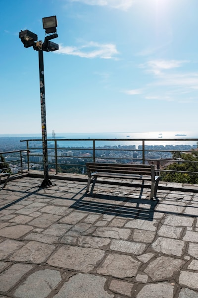 a wooden bench sitting on top of a stone floor