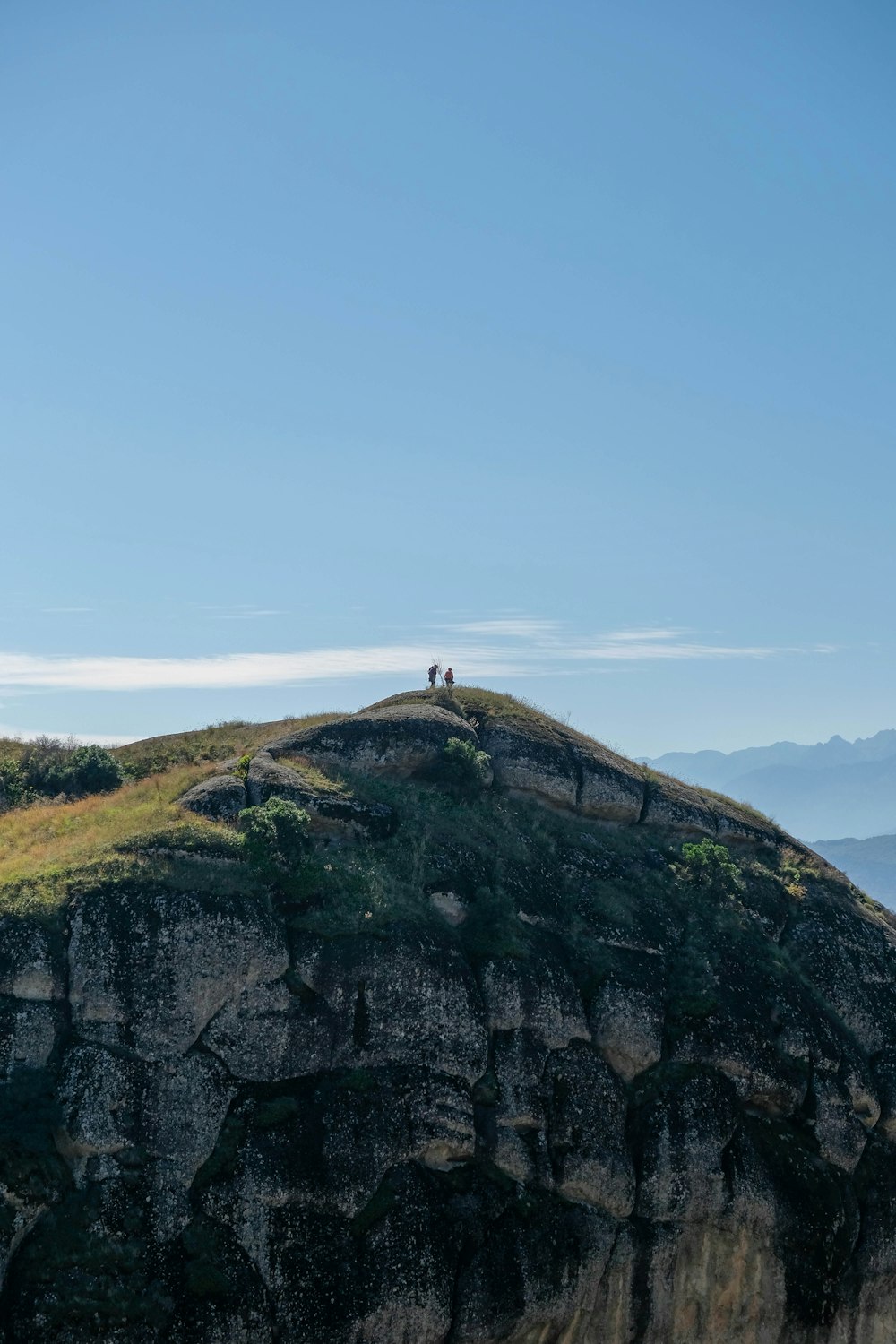 two people standing on top of a mountain