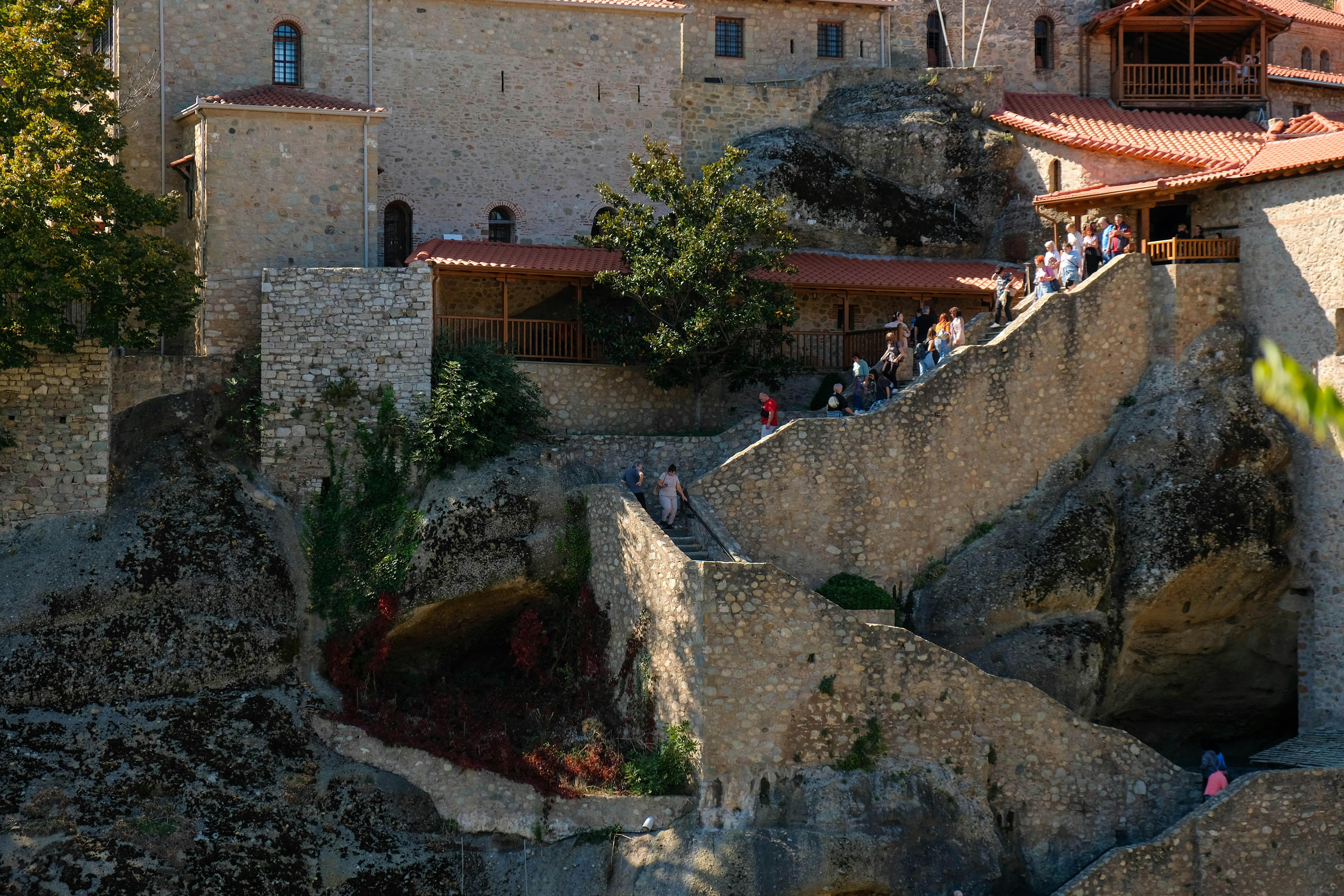 a group of people standing on top of a cliff