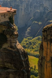Ancient stone monastery nestled in the green hills of La Rioja, bathed in warm sunlight.