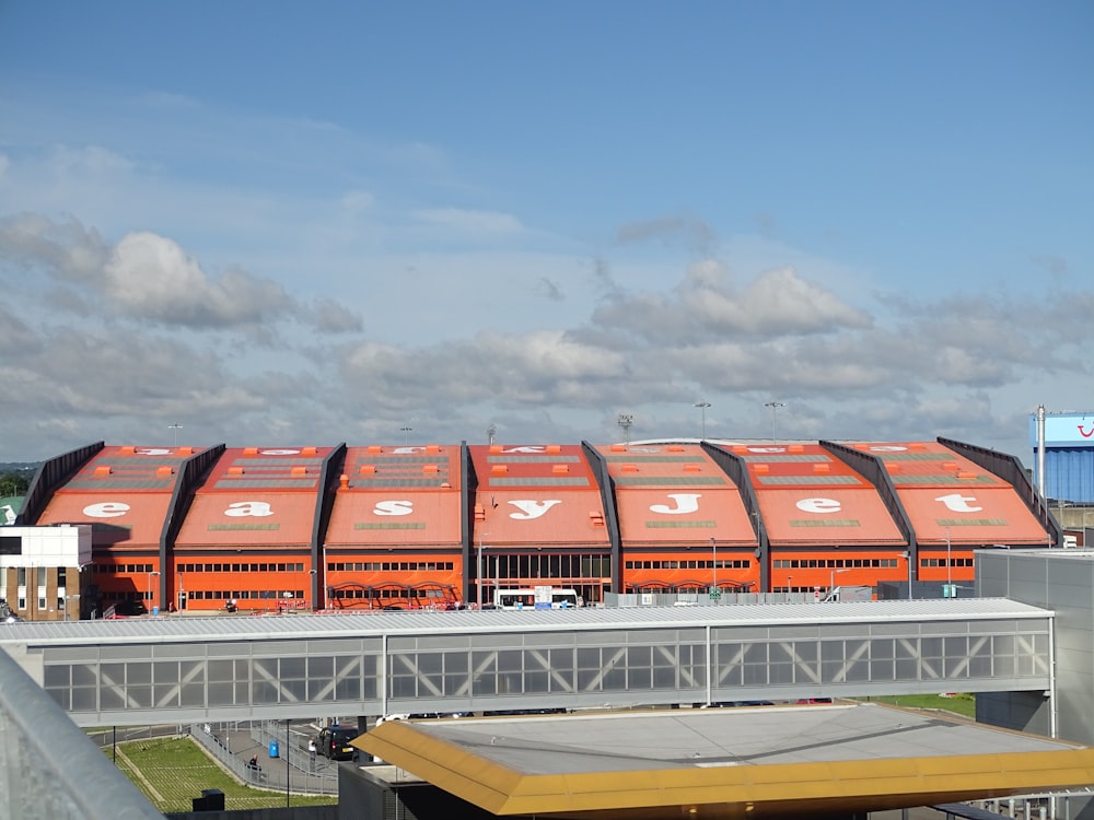 a large orange train on a steel track