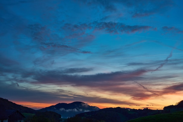 A picturesque sunset over rolling hills.