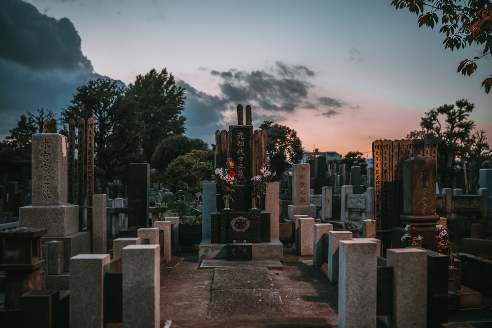 a cemetery with many headstones and trees in the background