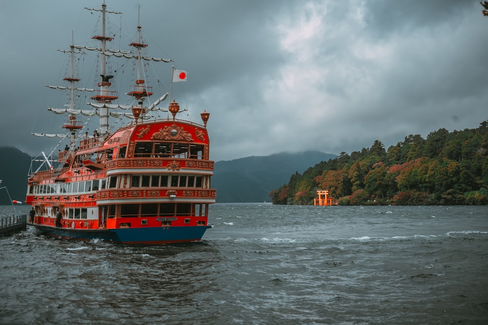 a large red and blue boat in a body of water