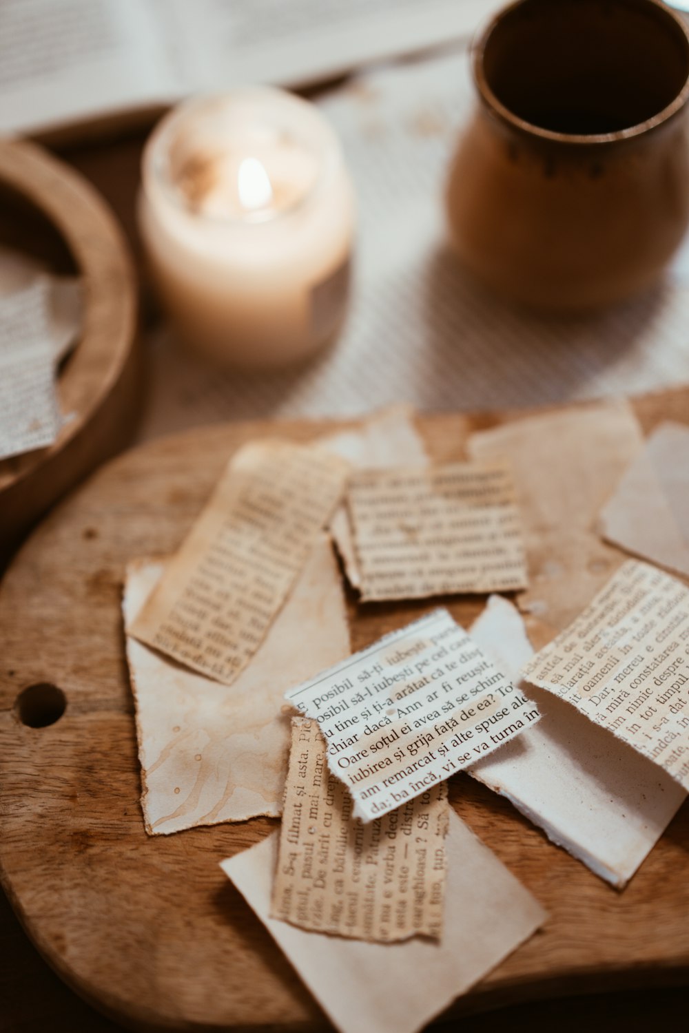 a wooden cutting board topped with lots of pieces of paper