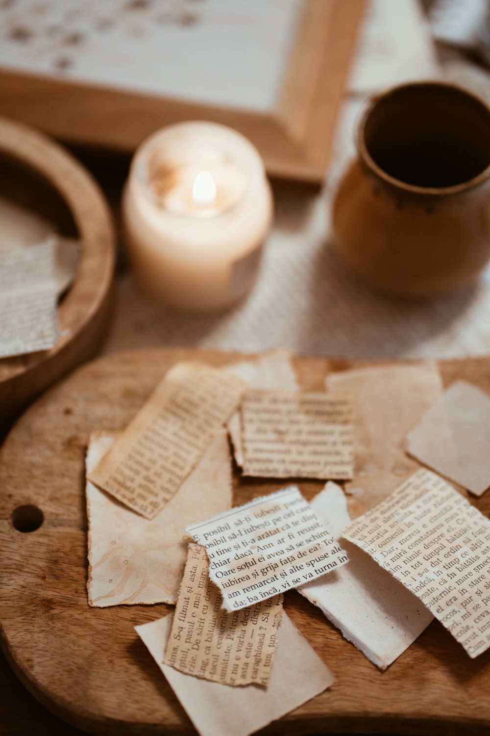 a wooden cutting board topped with lots of pieces of paper