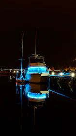 Underwater LED lights illuminating a yacht hull in deep blue water