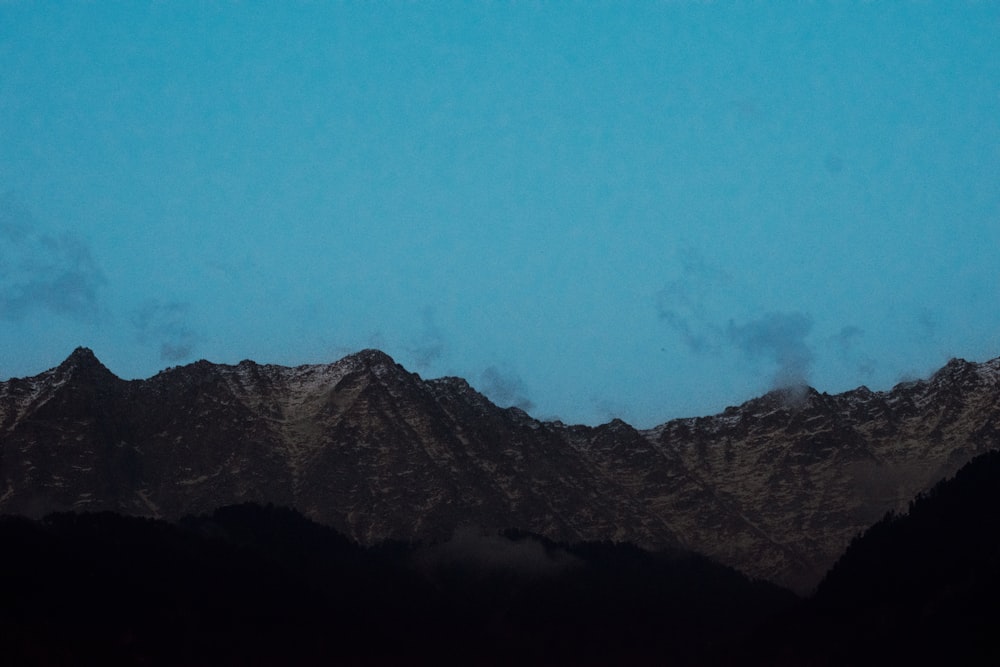 a plane is flying over a mountain range