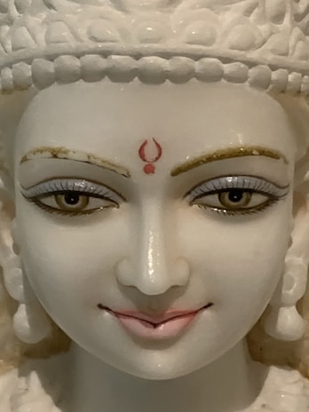 Marble religious idol with delicate carvings, capturing serene expressions.