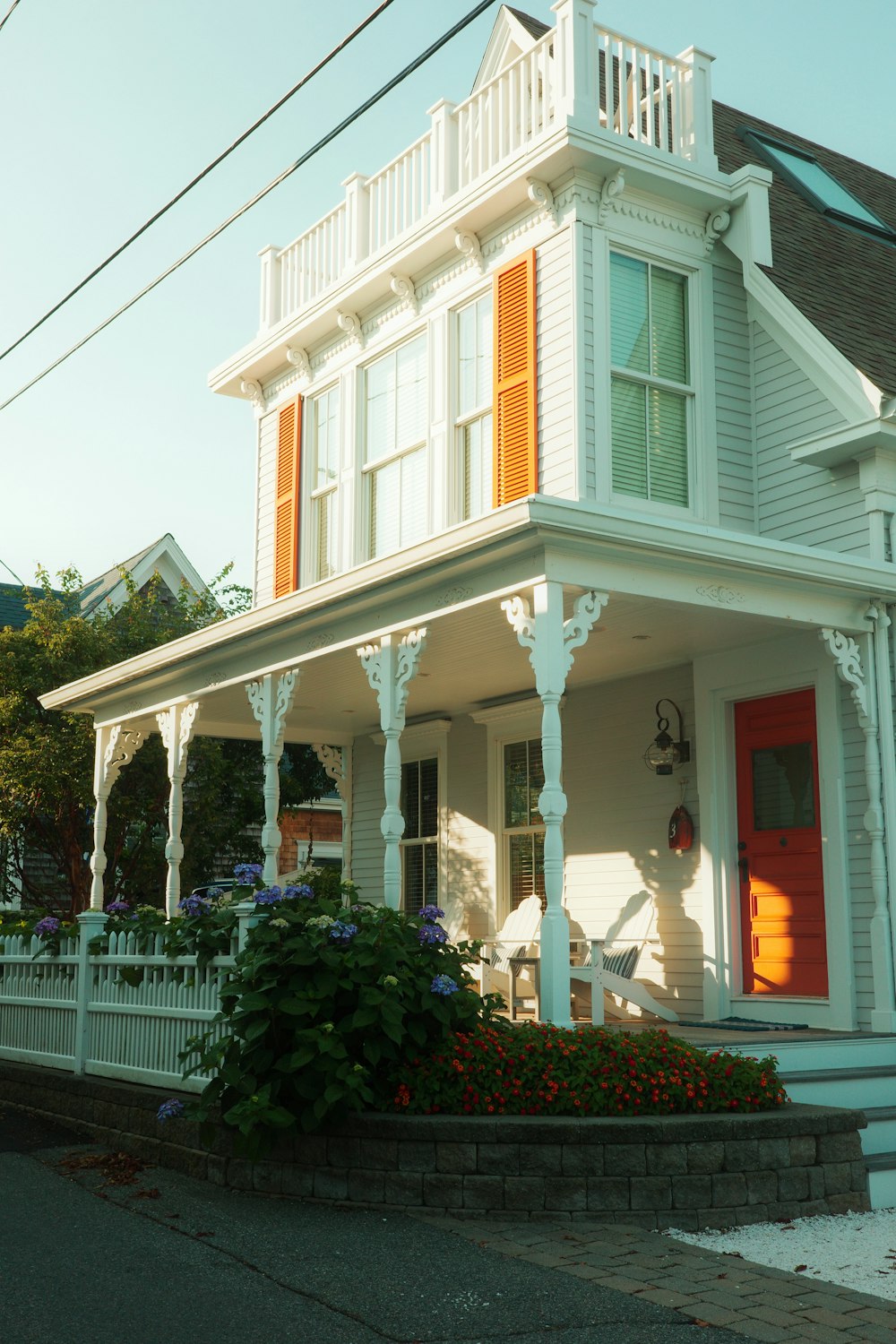 a white house with a red door and red shutters