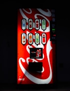 Close-up of a vending machine dispensing a refreshing beverage.
