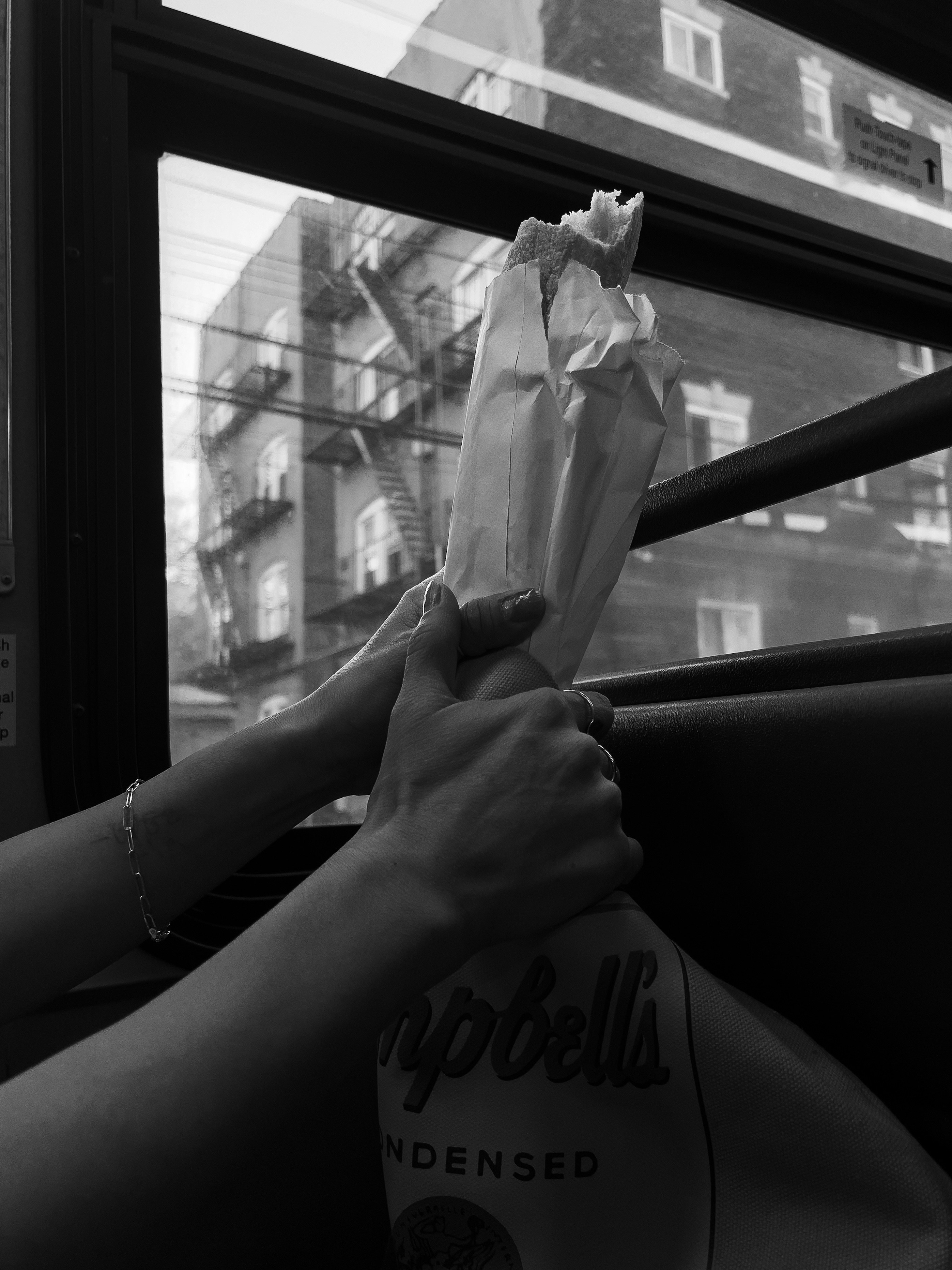 a person holding a paper bag on a bus