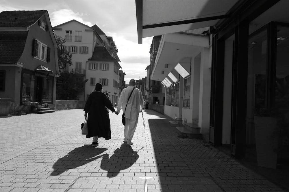 a couple of people that are walking down a street