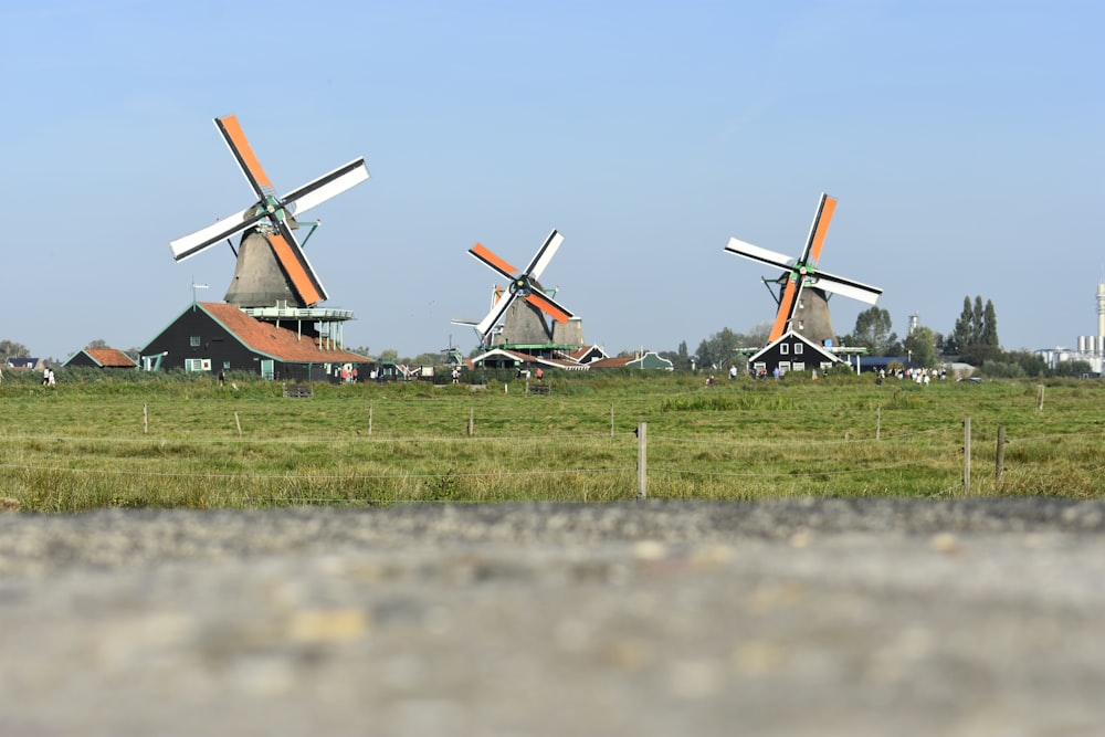 a row of windmills in a grassy field