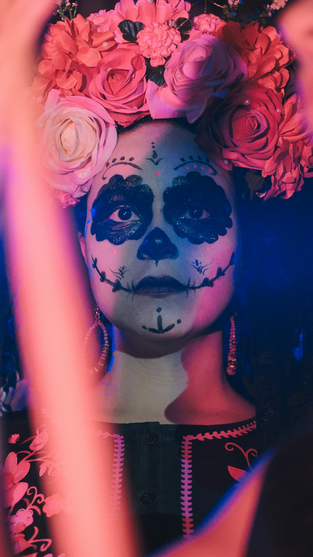 a woman with makeup and flowers in her hair