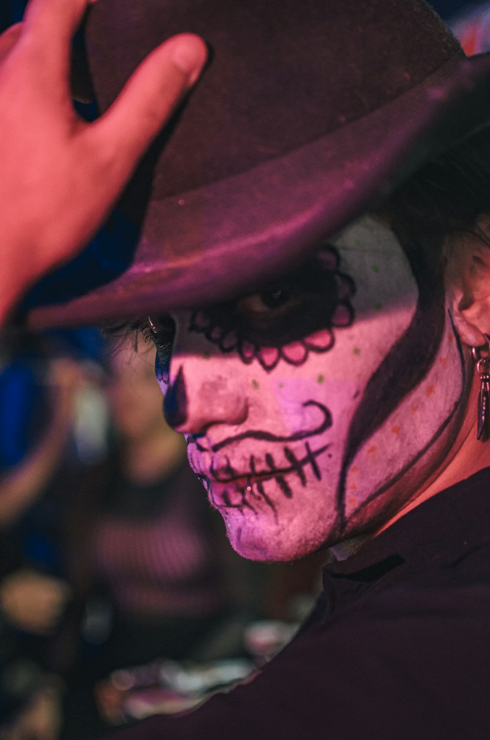 a man in a top hat and face paint