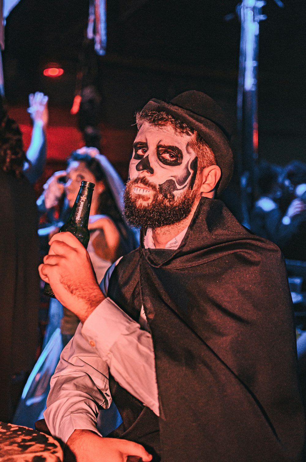 a man in a costume holding a beer