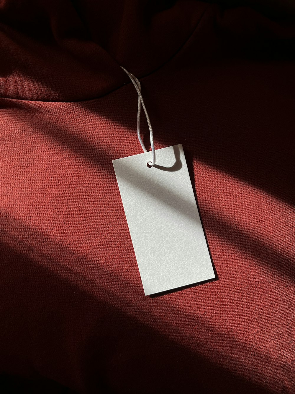 a red cloth with a white tag hanging from it