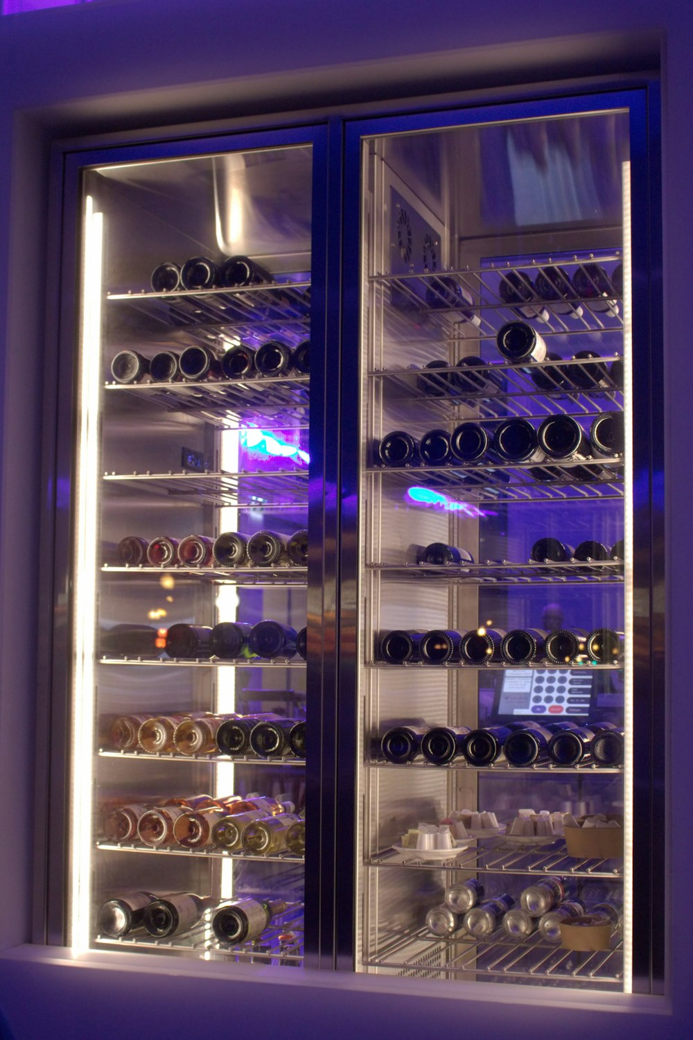 a wine cooler with many bottles of wine in it