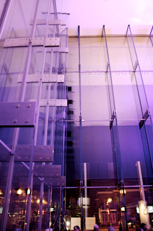 A sleek, modern office lobby bathed in natural light with purple accent walls.