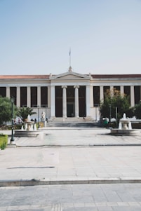 a large building with columns and a flag on top of it