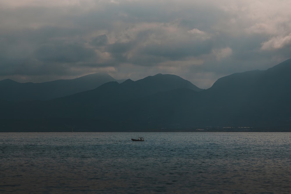 a small boat floating on top of a large body of water