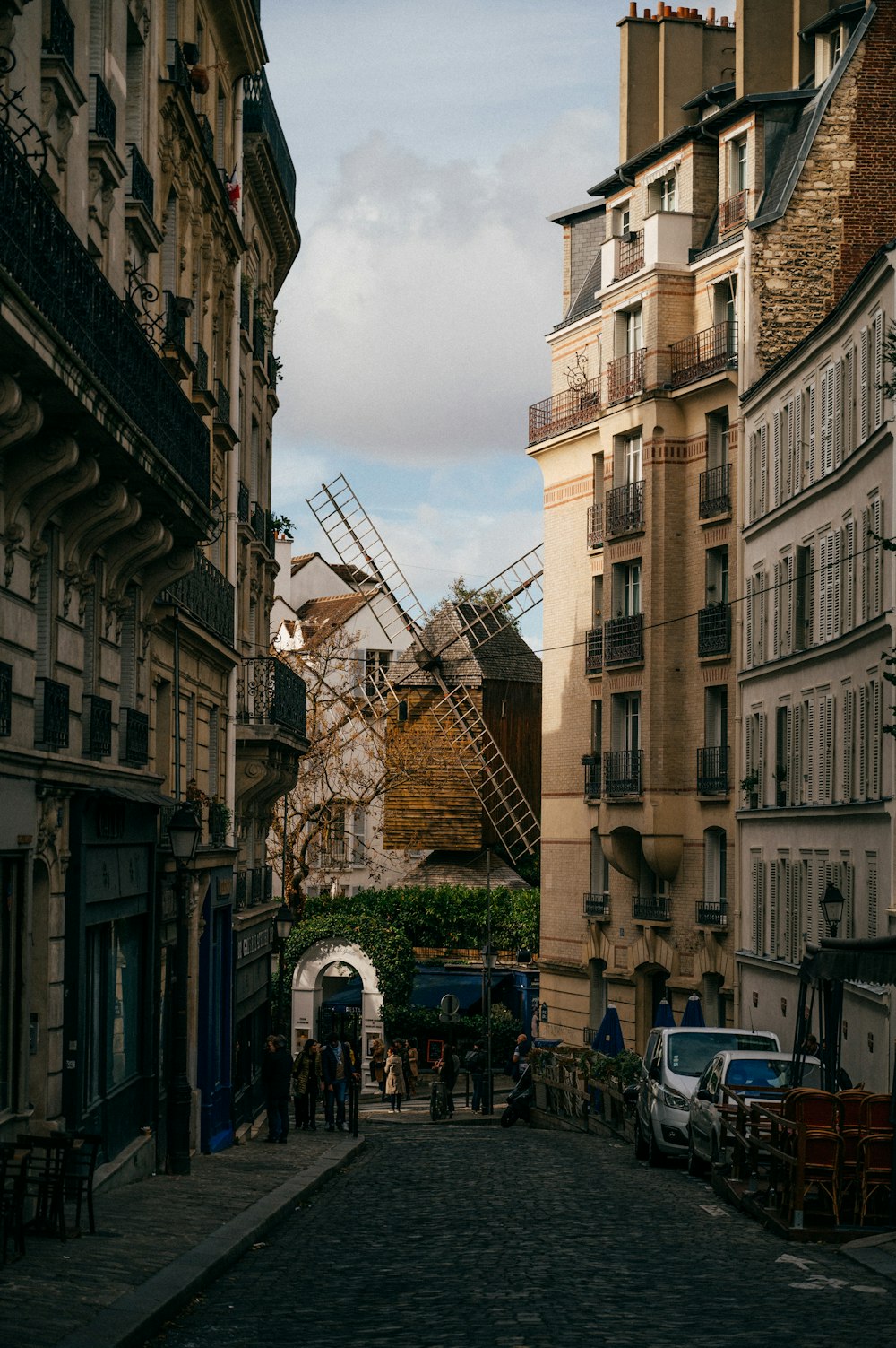 a cobblestone street lined with tall buildings