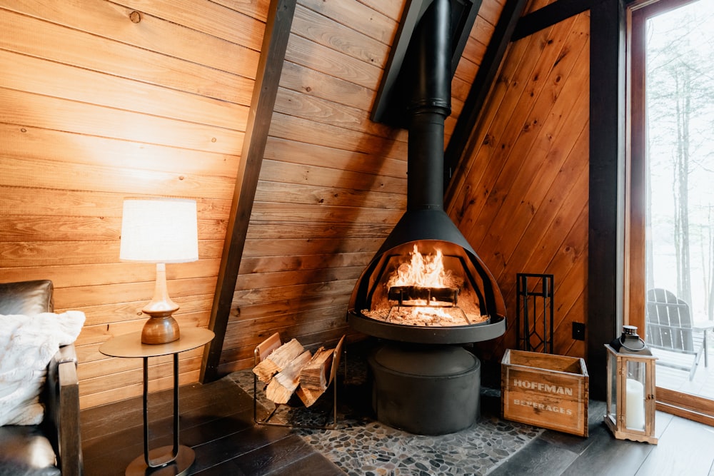 a wood burning stove inside of a wooden cabin