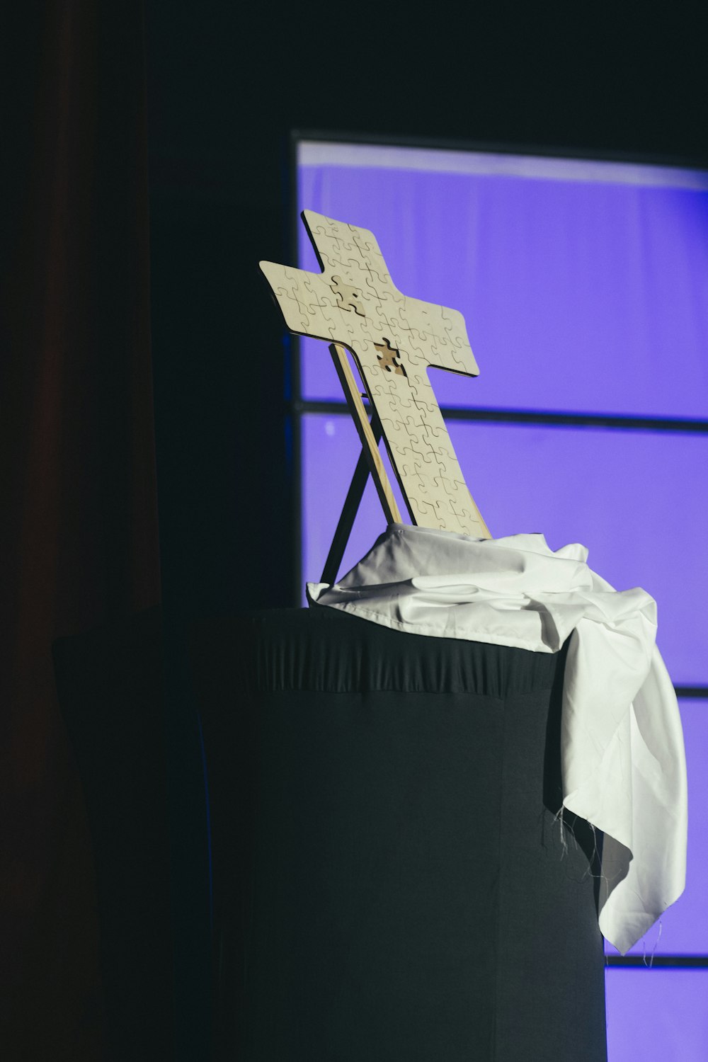 a wooden cross sitting on top of a table