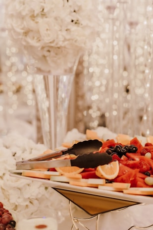 An aesthetic arrangement of fresh fruits and Venera water at a luxurious banquet.