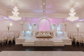 a banquet hall with tables and chairs and chandeliers
