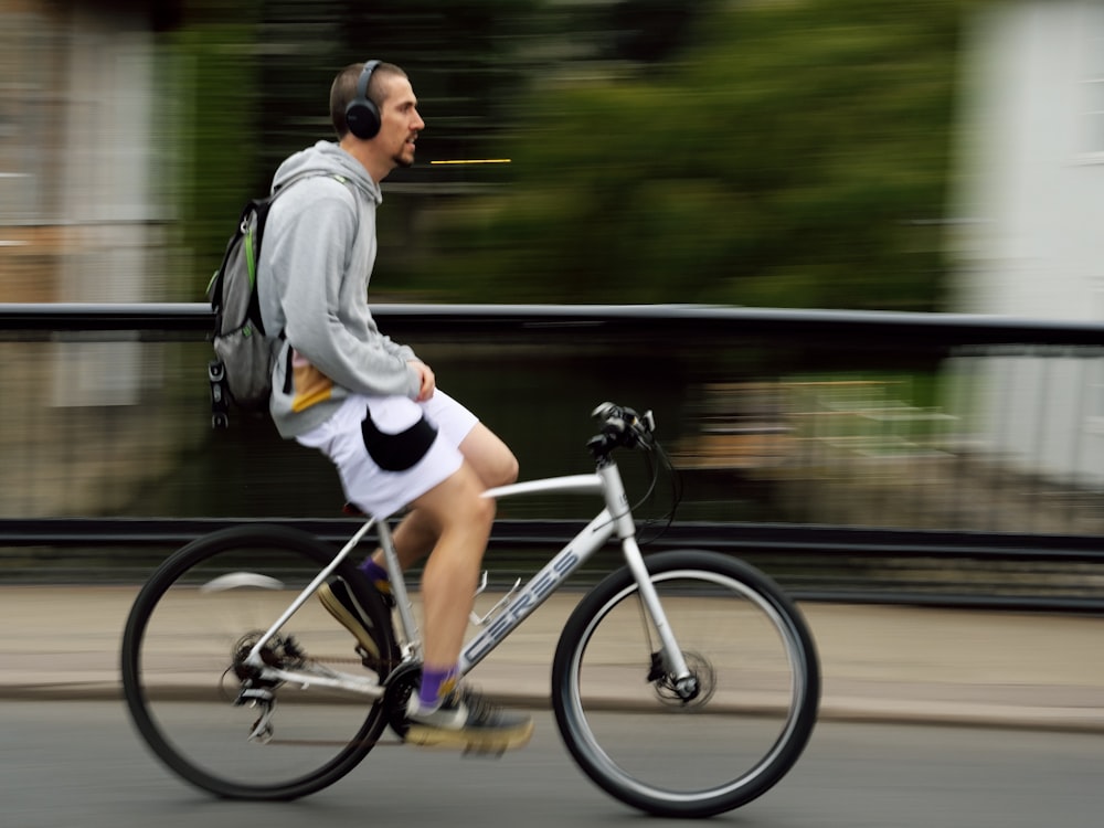 a man riding a bike down a street