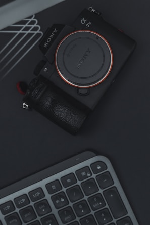 a camera sitting on top of a keyboard
