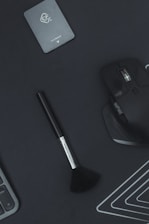 A sleek, dark-themed workspace with a laptop displaying influencer analytics and grooming products.