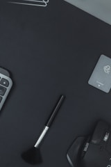 A minimalist flat lay of digital marketing tools on a dark red background.