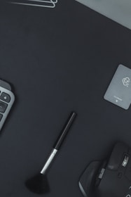 Flat lay of a minimalist workspace featuring a modern mouse pad and matching accessories.