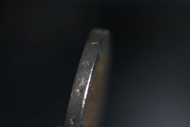 Side view of a replica coin showing its thickness and authentic edge pattern.