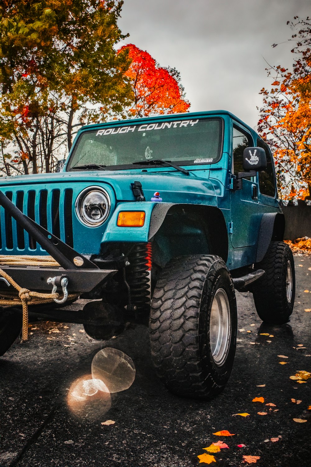a blue jeep parked in a parking lot