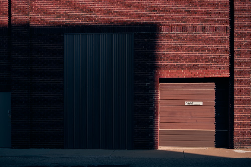 a red brick building with a black door