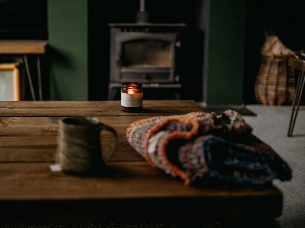 a table with a blanket and a candle on it