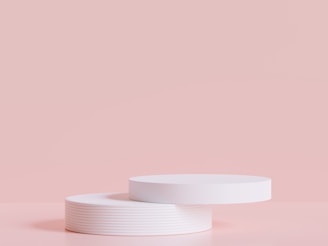 a white container sitting on top of a pink surface