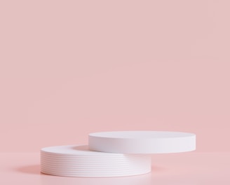 a white container sitting on top of a pink surface