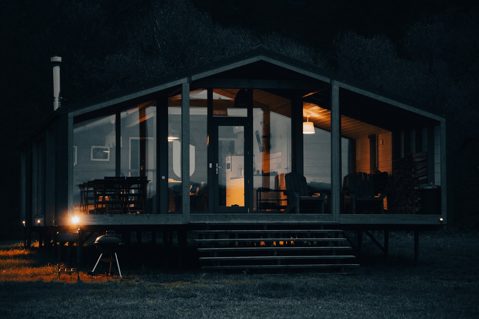 An interior view of a cozy, well-lit portable cabin featuring wood finishes and comfortable furnishings.