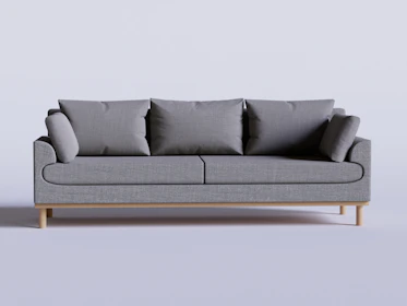 A sleek Scandinavian-style teak sofa with soft cushions in a bright, airy room.