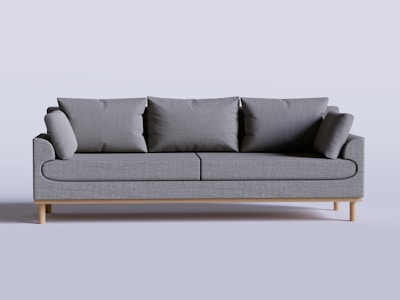 A custom-built sofa with soft cushions and wooden armrests in a stylish flat interior.